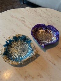 two blue and purple glass bowls on a table